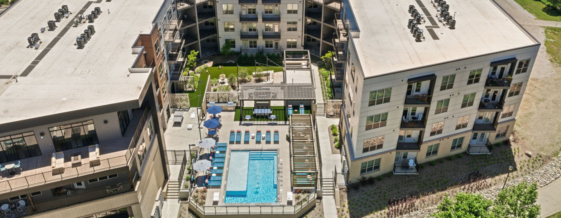 Arial view of The Mill at Ironworks Plaza's pool and apartment buildings
